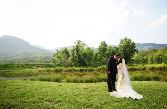 bride groom kiss at outdoor wedding ceremony