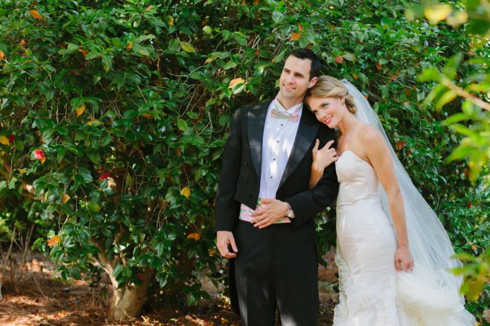 Romantic bride and groom pose outside their wedding venue