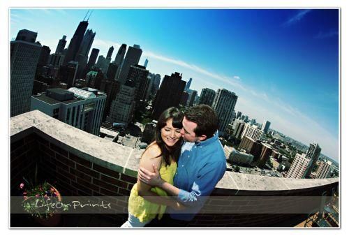 Groom kisses bride while standing on balcony overlooking Chicago skyline