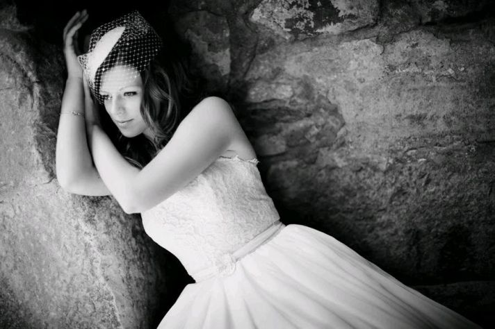 Stunning black and white photo of bride in white strapless chantilly lace wedding dress and birdcage