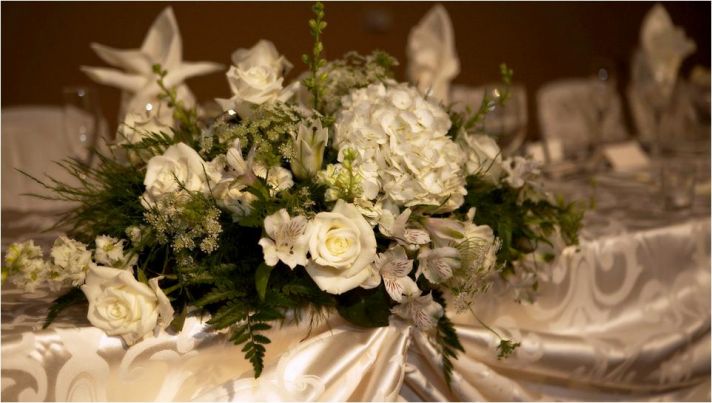 Classic ivory, champagne and green tablescape at wedding reception