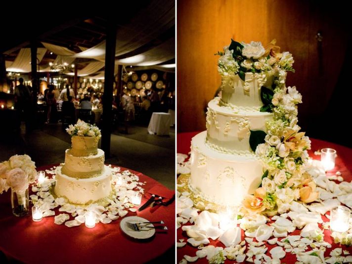 Classic white three-tier wedding cake adorned with white and ivory flowers