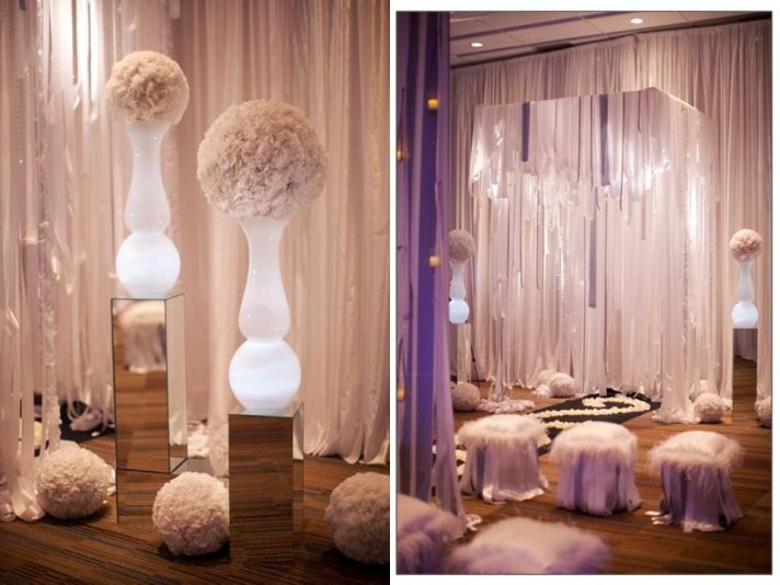 Frosted glass vases illuminated with white wedding flower arrangement on top; romantic wedding cerem