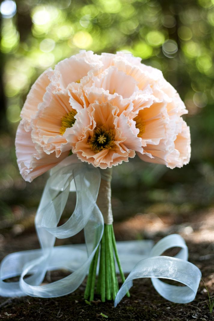 Handmade paper flowers bridal bouquet in romantic peach tied with sage green ribbon