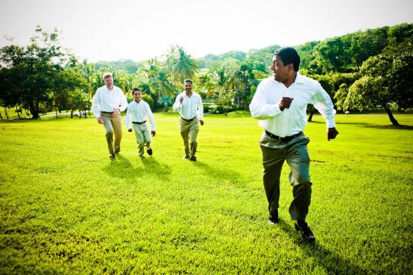 Groom and groomsmen run to wedding ceremony