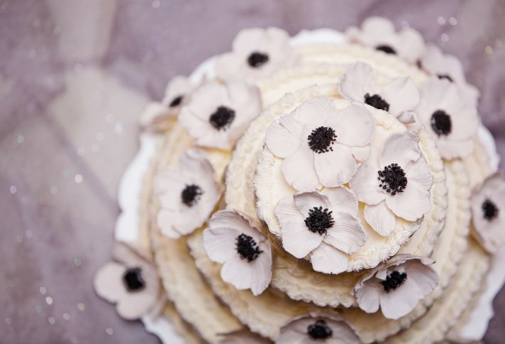 Elegant ivory wedding cake with sugar anemone flowers