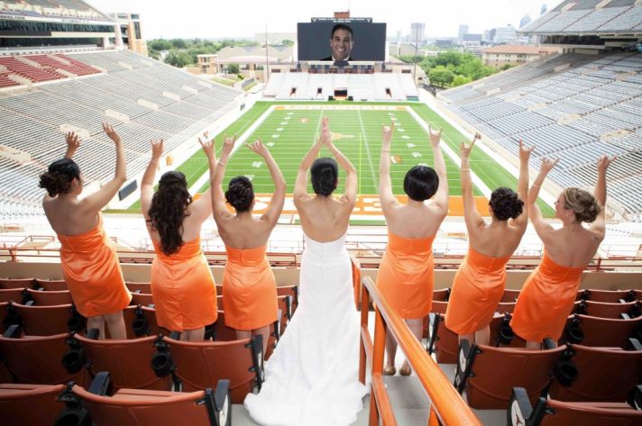 sports themed wedding bridesmaids wear orange bride wearing white wedding dress