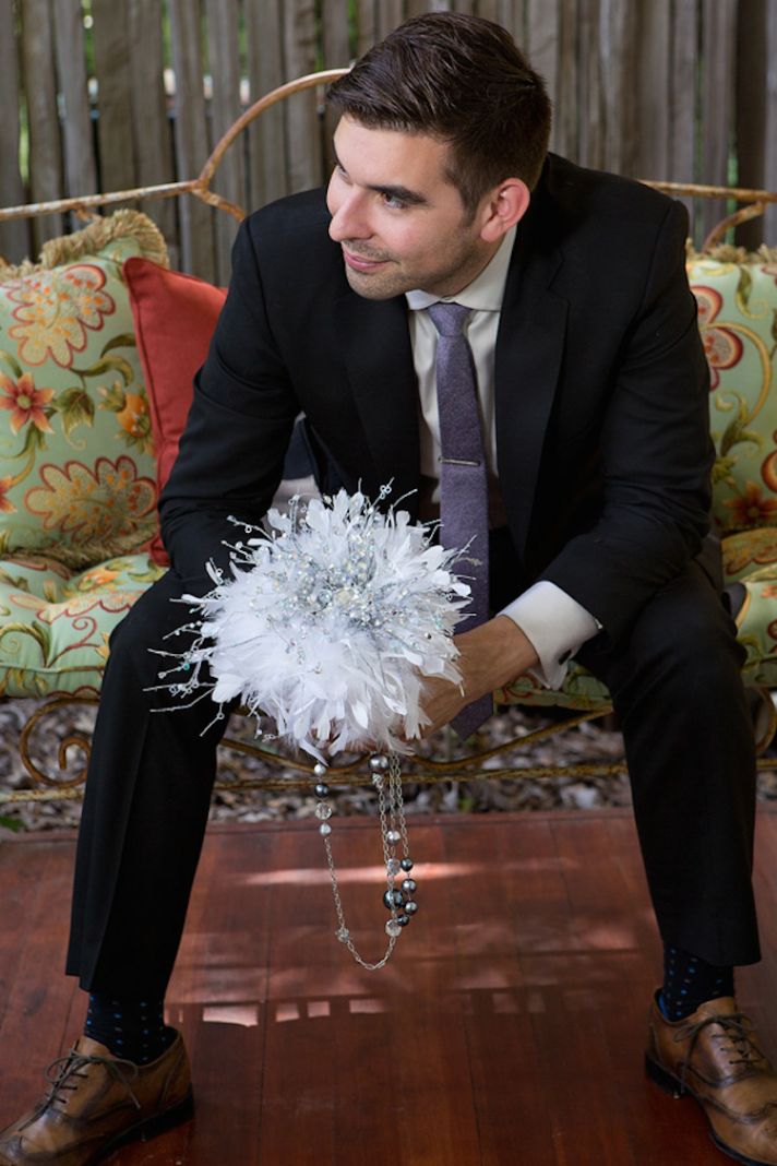 Groom with white feather bouquet