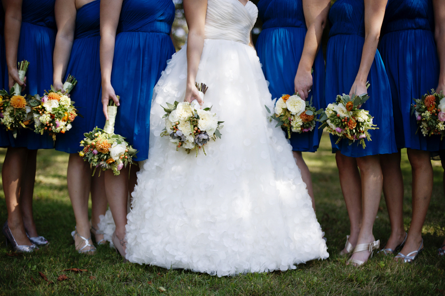 Bride-poses-with-bridesmaids-in-blue-showing-off-bouquets.full