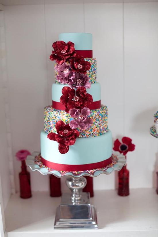 photo of Whimsical Wedding Cake with Rainbow Sprinkles Red Blooms