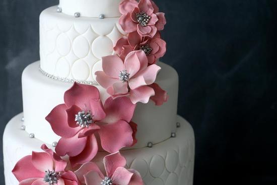 photo of Elegant White Wedding Cake with Light Pink Blooms Silver Beads