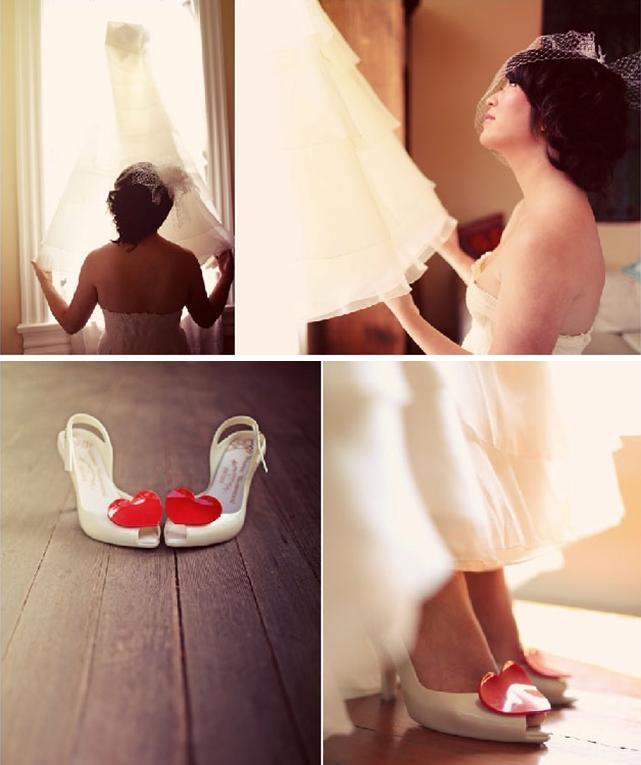 Wedding-shoes-white-with-red-heart-bride-looks-up-at-white-wedding-dress-in-window.full