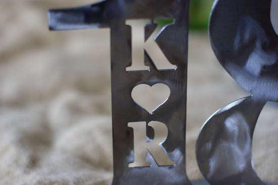 Monogram cut out on wedding table number
