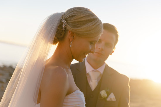 Sleek bridal updo low chignon with rhinestone barret and veil