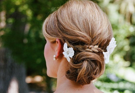Low twisted bun wedding hairstyle with braid
