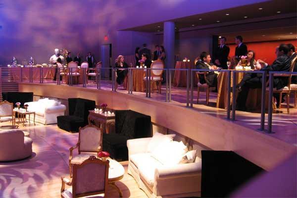 Adding-furniture-to-wedding-reception-purple-lights-white-black-couches-and-chairs.full