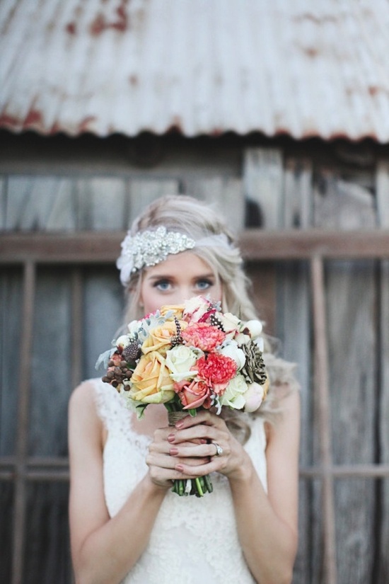 Bride wears beaded wedding bandeau holds romantic bouquet