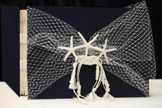 Starfish and tulle adorned wedding guest book