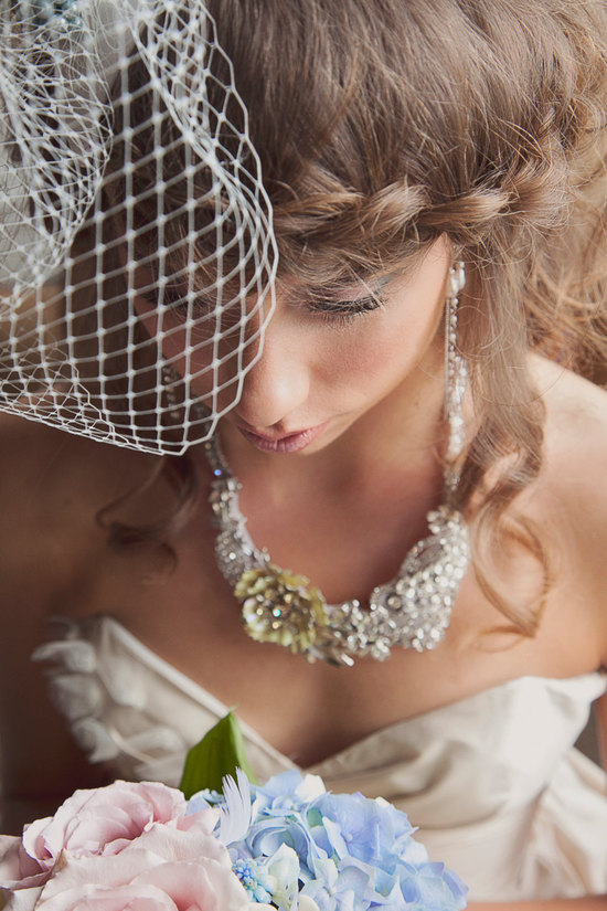 Braided wedding hairstyle with chic birdcage veil