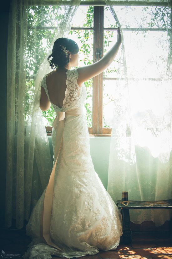 Romantic bride shows off lace low back wedding dress