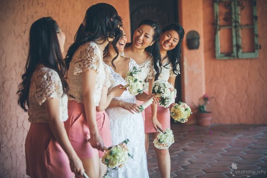 California bride laughs with bridesmaids by her side