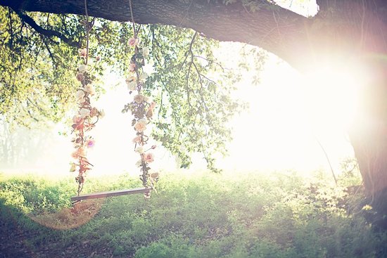 photo of ethereal summer wedding ideas floral swing hanging from tree