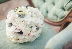 photo of romantic ivory wedding bouquet with anemones and roses