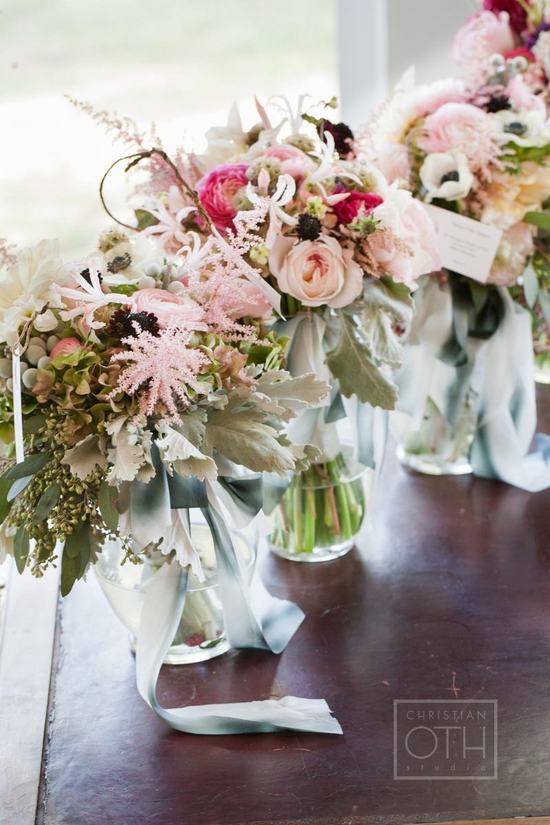 Romantic summer bride walks with bridesmaids through the woods
