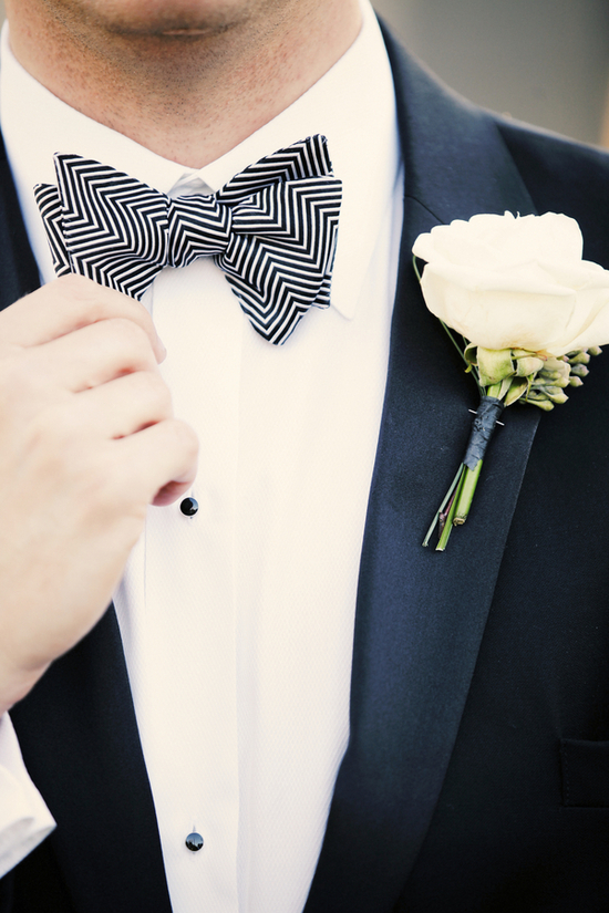 Classic groom wears tux with zig zag bow tie