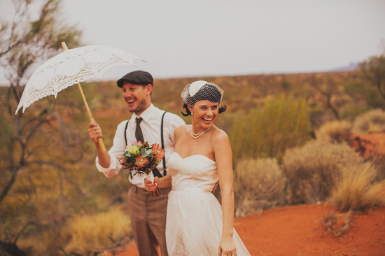 Eloped in Uluru - Bride poses with her groom beneath a lacy parasol