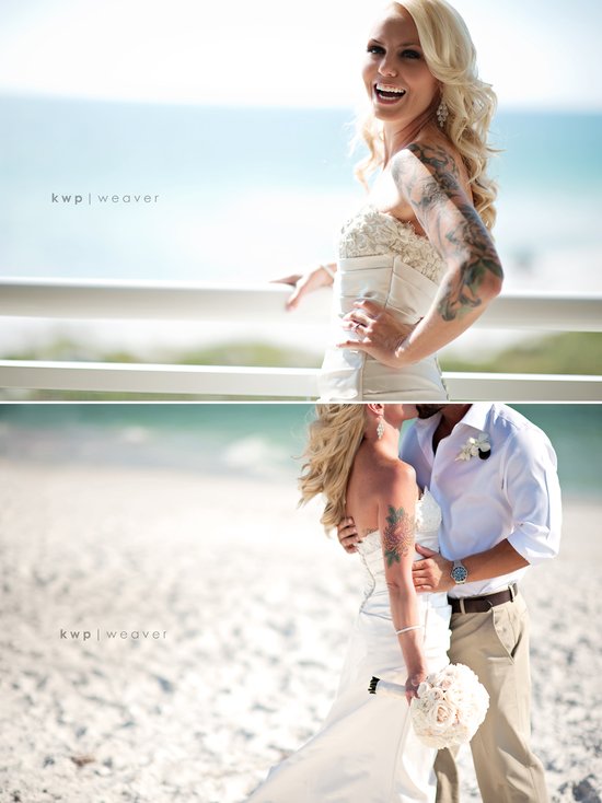 Glamourous tattooed bride kisses groom on the beach