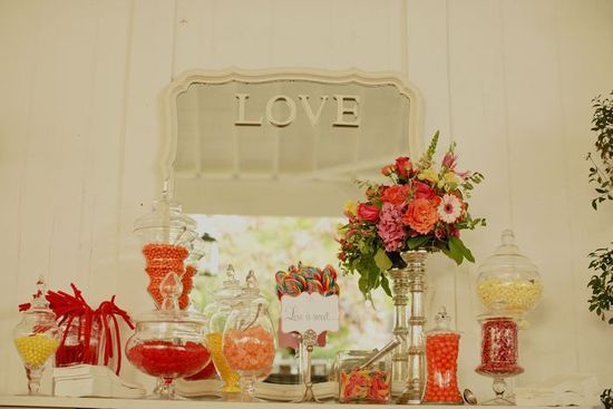 Vibrant wedding reception candybar and wedding flower centerpieces