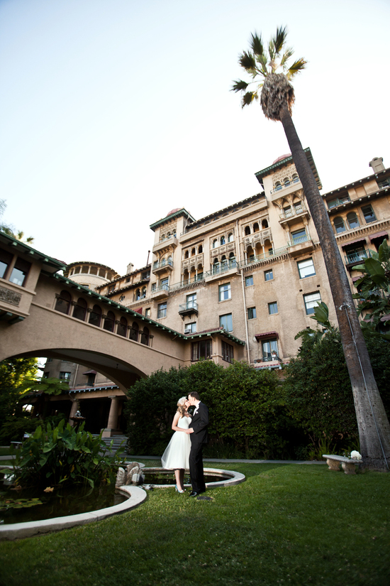 Bride and groom kiss outside mediterranean venue