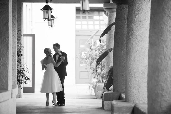 Bride and groom kiss outside mediterranean venue