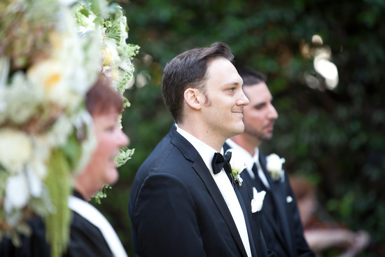 Bride and groom pose with wedding party outside