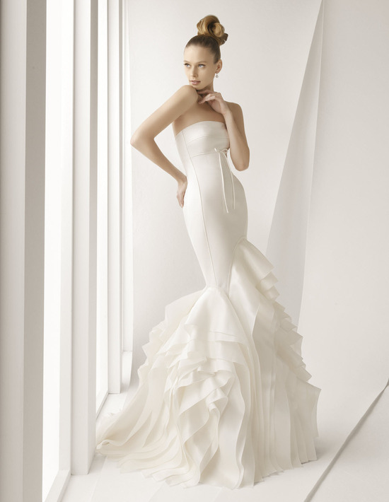 Stunning ivory strapless mermaid wedding dress with textured skirt and dainty bow