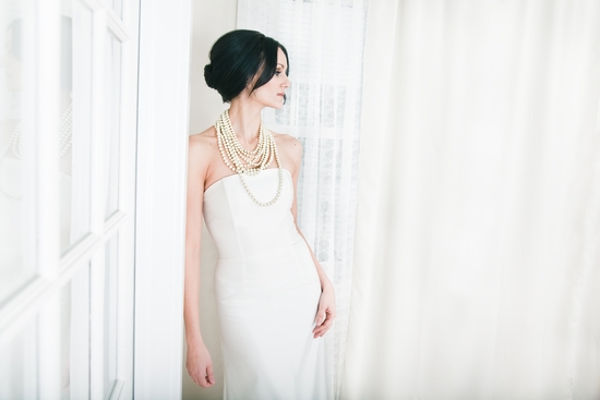 Stunning high bun bridal updo with romantic wedding makeup and gown