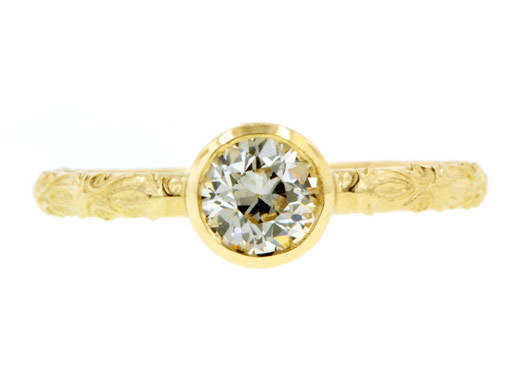 photo of Simple hammered gold engagement ring with round diamond center stone