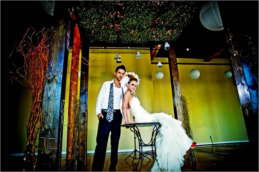 Edgy-rock-and-roll-bridal-shoot-white-strapless-wedding-dress-unkempt-groom-with-opened-shirt-and-tie-colorful-wedding-reception-decor.full