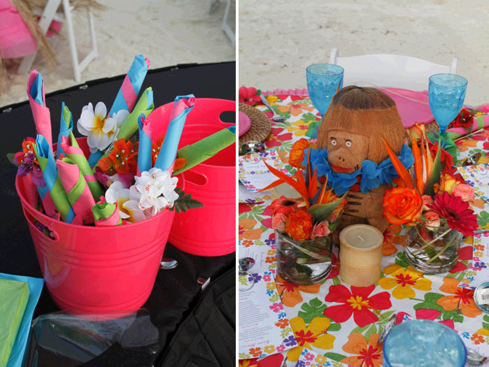 Pink-beach-pails-hold-silverwear-adorned-with-tropical-flowers-cute-monkey-centerpiece-and-floral-tablecloth.full