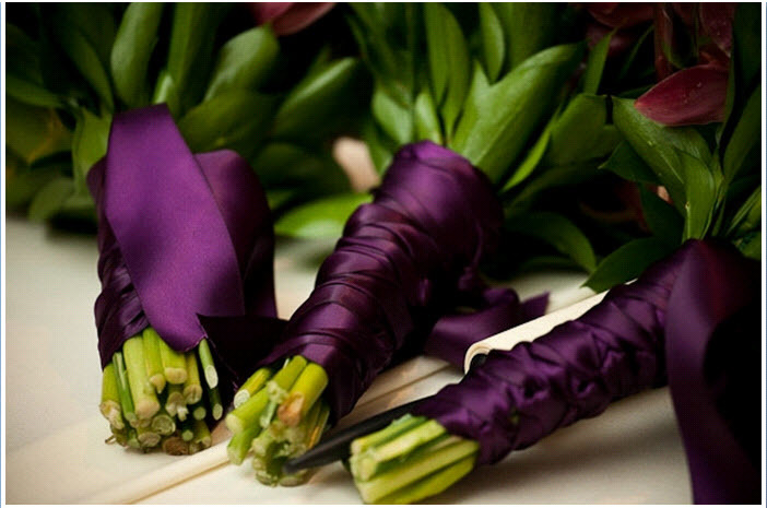 Wedding-detail-shot-romantic-bridal-bouquet-and-bridesmaids-flowers-tied-with-eggplant-purple-satin-ribbon.full