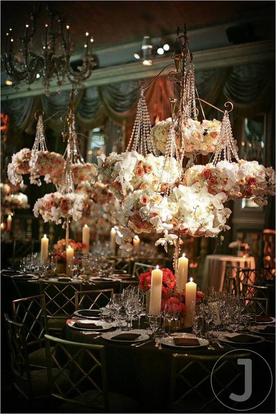 This romantic wedding tablescape is created with hanging flowers and dusty rose candles. It creates