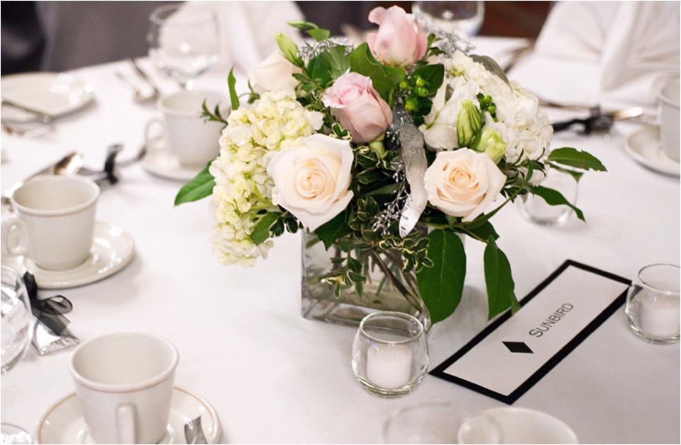 Personalized-wedding-idea-guest-tables-at-reception-name-different-ski-slopes-the-couple-love-low-peach-pink-ivory-table-centerpiece.full