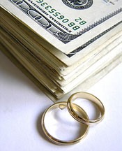 This pile of money with two gold wedding rings next to it shows us that money and weddings are relat
