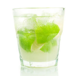 photo of A refreshing caiprinha with lime, mint, and ice in a glass.