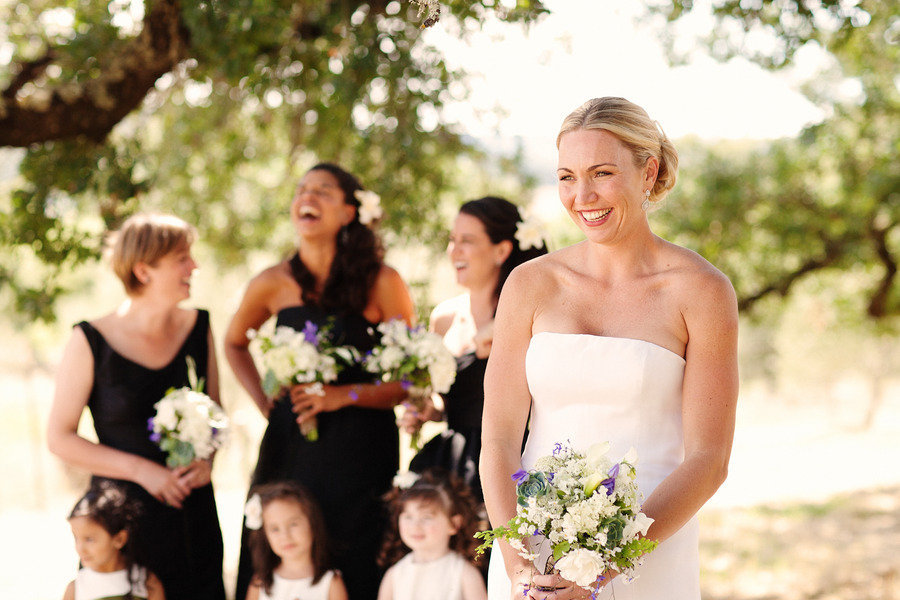 Bride-smiles-with-bridesmaids-in-back.full