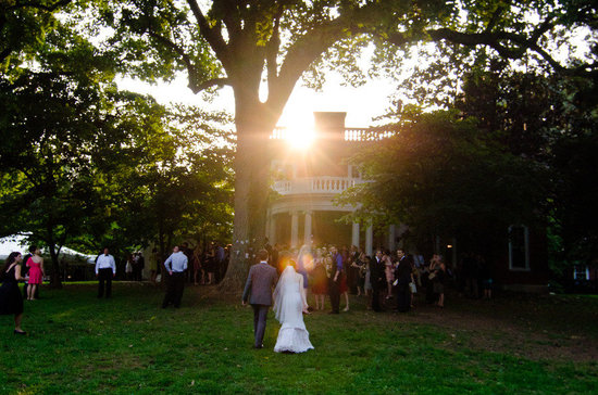 bride groom walk hand in hand into wedding reception venue