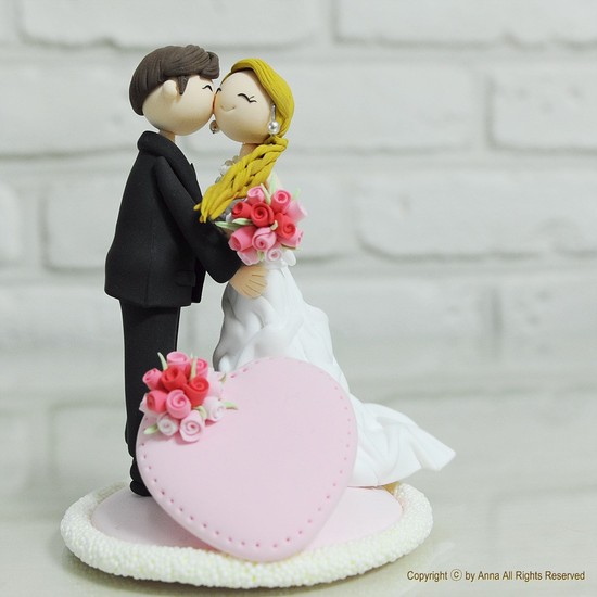 photo of Cute clay wedding cake topper