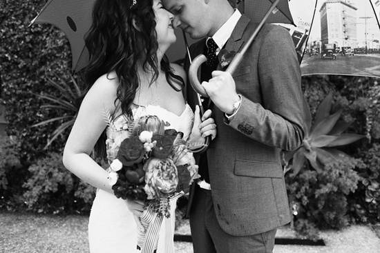 photo of bride groom pose under umbrellas outdoor wedding love theme