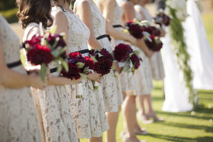 Lace-printed-bridesmaids-dresses-black-sash-red-bouquets.medium